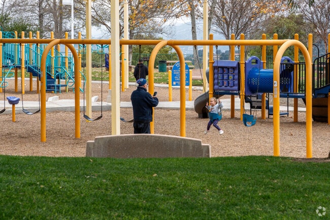 A man takes videos of a little girl swinging at the playground in Stevenson Ranch.