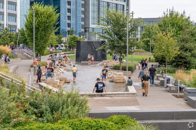Families enjoy the fun water features of the downtown Vancouver Waterfront.