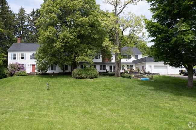 A very large colonial that sits on dozens of acres used for farming.