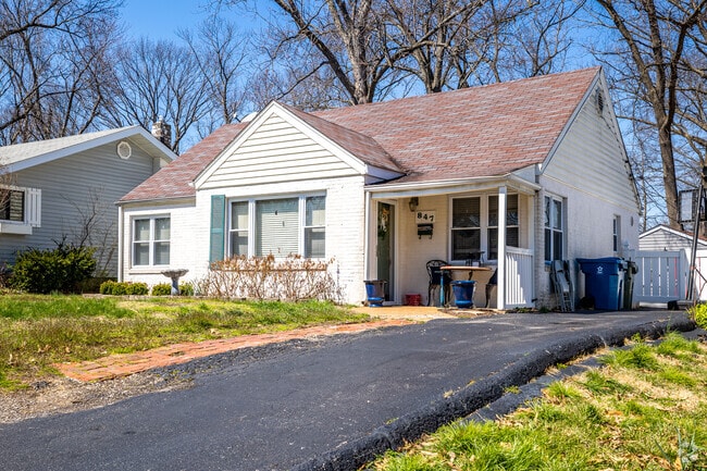 A small cape cod home shaded by large trees in the Glendale neighborhood