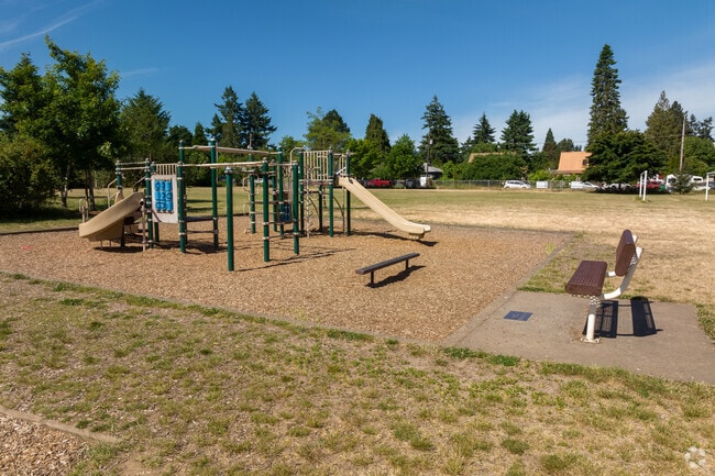 The play structure and bench behind the Rigler Elementary School.