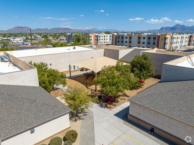 A courtyard featuring a shaded playground is on the Imagine East Mesa School campus.