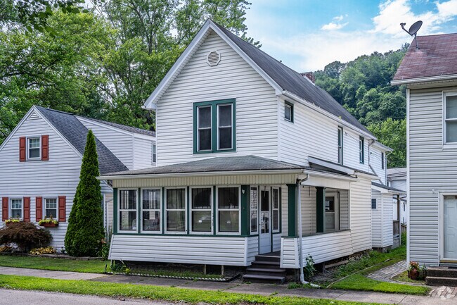 Some homes in Wellsville have their front porches converted to an all weather room.
