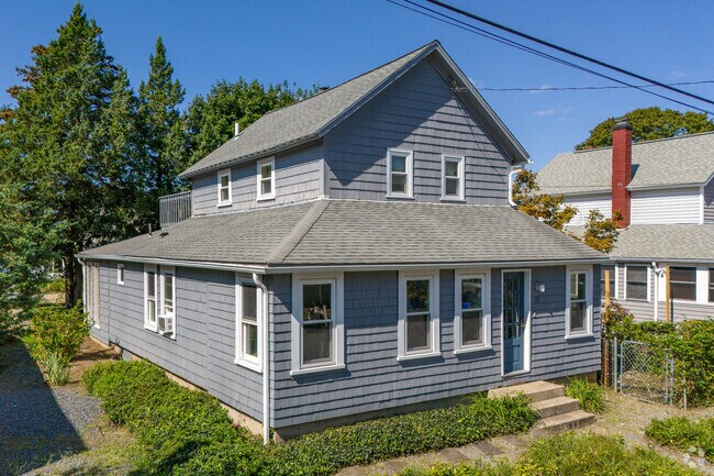 A classic Bay Spring cottage upgraded with an inviting wrap around porch for relaxing views.