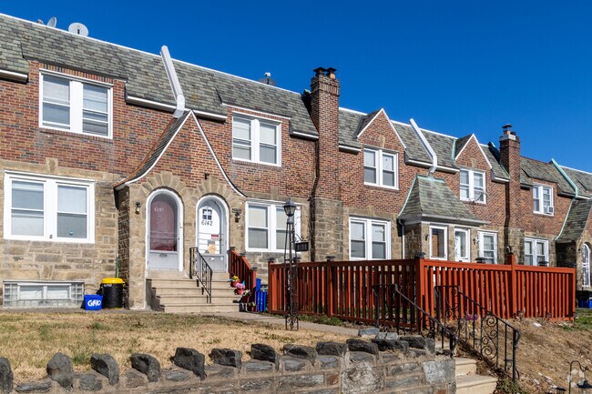 The home owner of this brick & stone row home has fenced in their front lawn.