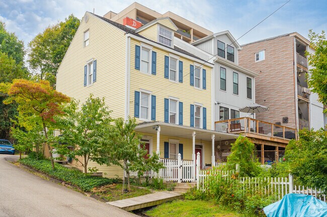The yards of some Polish Hill homes are beautiful with lush gardens and white picket fences.