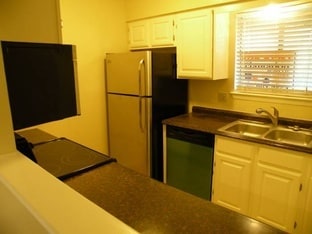Kitchen with hard surfaces and stainless appliances