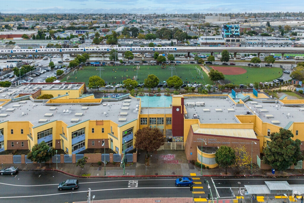 Aerial view of the Think College Now School with BART in the background.