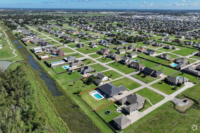 Beautiful landscaping and manicured lawns surround the elegant homes of The Lakes.