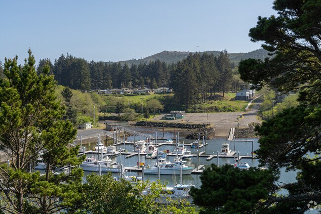 The Coast Guard leads a procession of flower clad boats for the Fleet of Flowers.