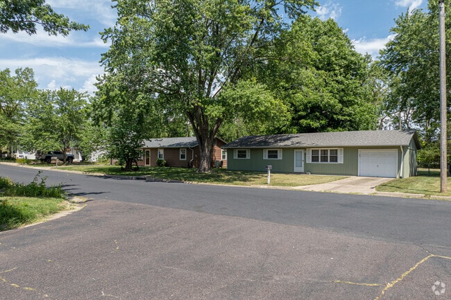 Modest ranch-style homes sit under large trees throughout Rockbridge.