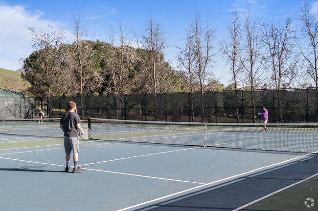 Tennis action Community games at Arbolado Park, Northgate.