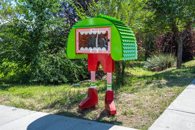 A monster-themed Little Free Library reflects the family-friendly atmosphere.
