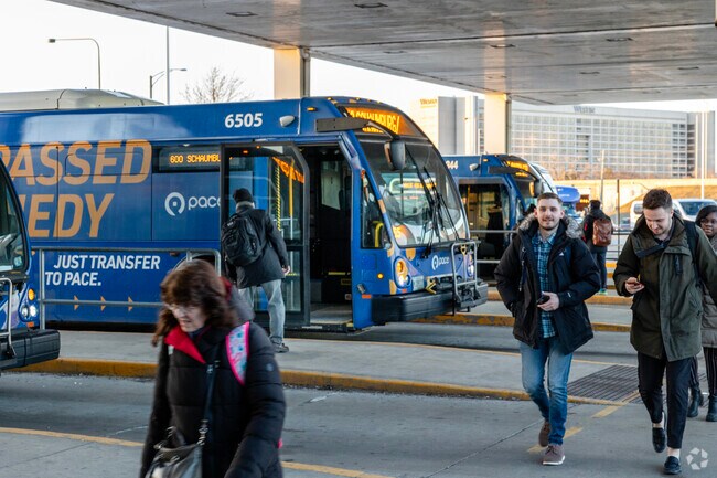Commuters switch from bus to rail at the Rosemont CTA transit hub.