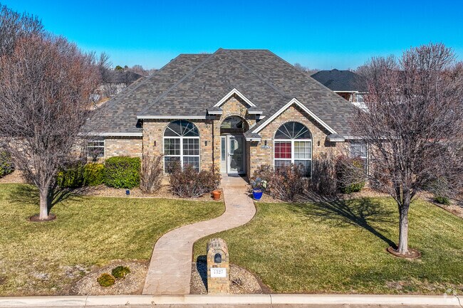 Portales homes are set along wide streets with no sidewalks and have gravel and grass lawns.