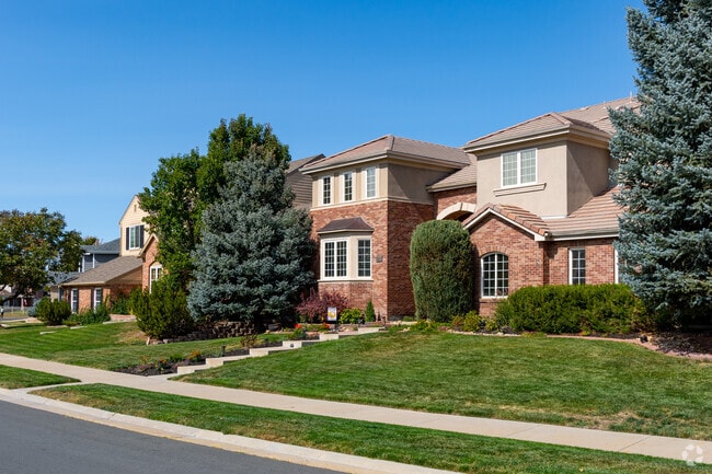 Rows of large homes with brick accents are common in Tuscany.