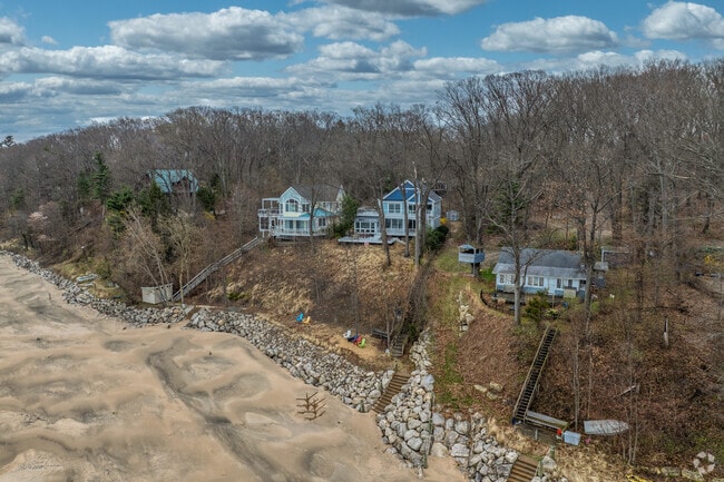 Lakeside homes, in Lake Michigan Beach, sit atop cliffs with steep steps leading to the beach.