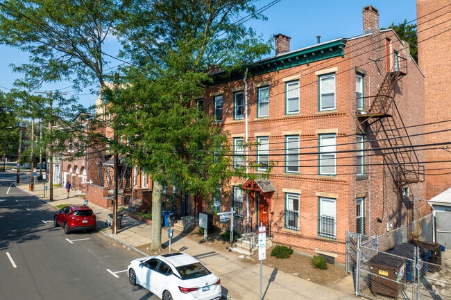Brick rowhouses and stone walls lend Downtown New Haven historic character.