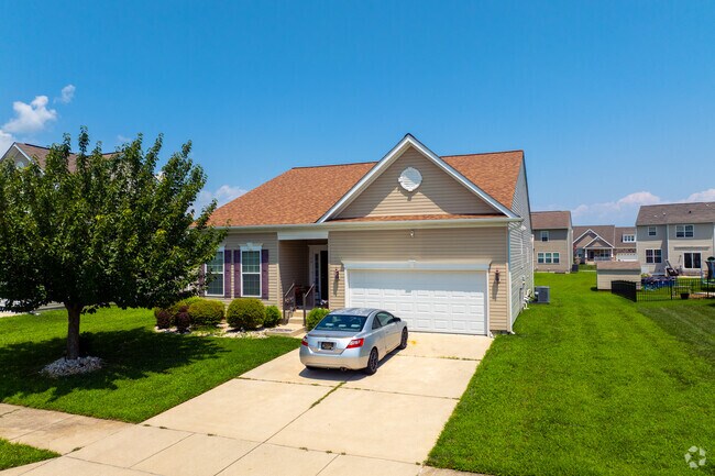 Single-family homes in Magnolia feature spacious driveways, green lawns, and quiet suburban surroundings.
