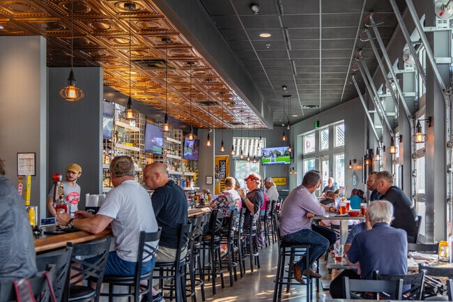 Locals grab a cocktail and food at Benchmark Sports Pub + Eatery in Berry Farms Town Center.