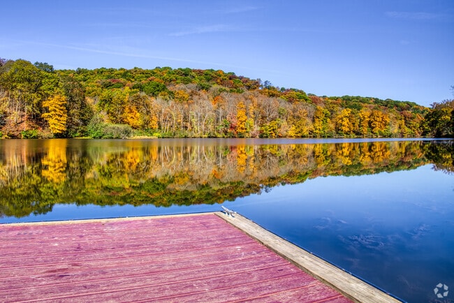 The colors of autumn reflect in the lake at Raccoon Creek State Park in Hanover Township.