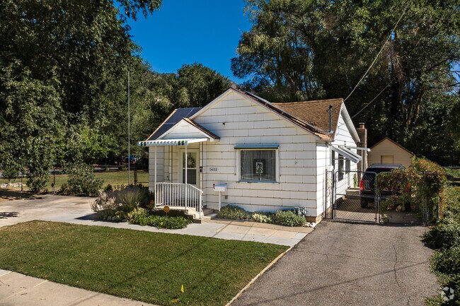 Mature trees surround this white home in Canyon Road.