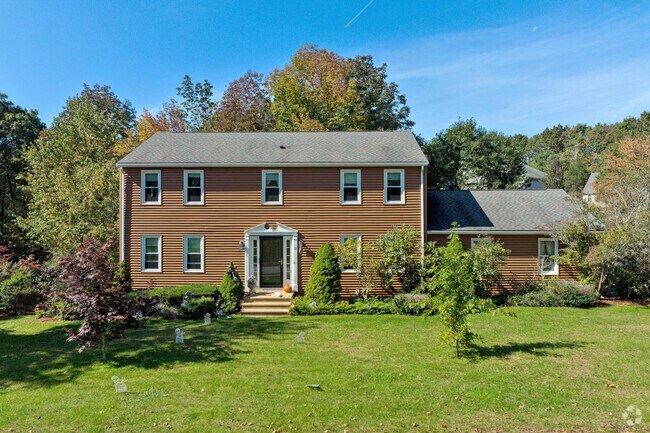 A colonial style home with a large front yard in Rutland.