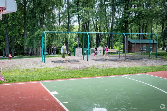 Friends and family enjoy the swings at Meadow Park.