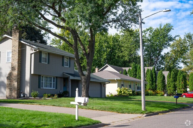 Classic split-level and ranch-style homes in Maplewood Heights, set along a quiet, tree-lined suburban street.