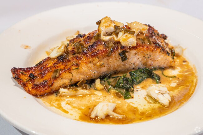 Herb Crusted Salmon topped with jumbo lump crabmeat and champagne beurre blanc sauce at Vincent's Italian Cuisine.