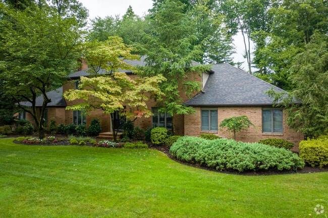 A new brick colonial with a manicured lawn in Woodcliff Lake, NJ.