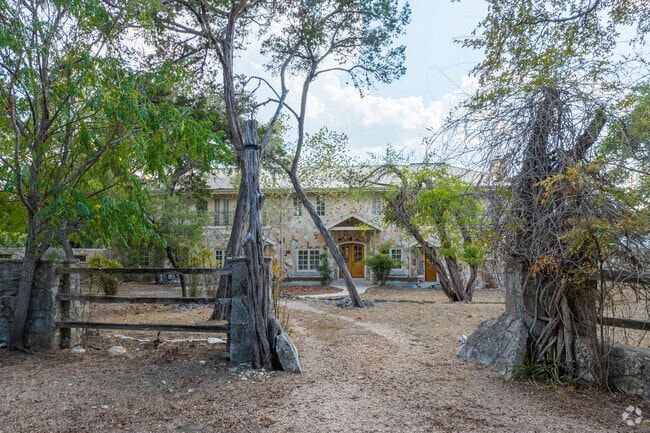 Stunning two-story home with stone facade, nestled by the Blanco River's scenic beauty.