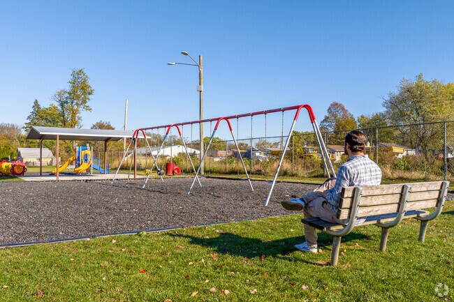Sit on the bench on while the kids touch the sky on the swingset in Boothwyn at Kingsman Park.
