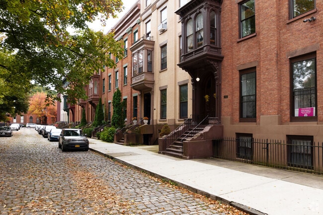 A view down a street next to Washington Park, a historic cobblestone corner of Troy, NY.