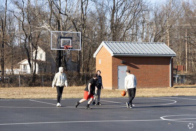 Friends play basketball on the courts at Gene Mason Sports Complex.
