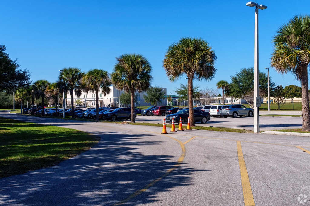 The entrance of Little River Elementary School is adorned with welcoming large palm trees.
