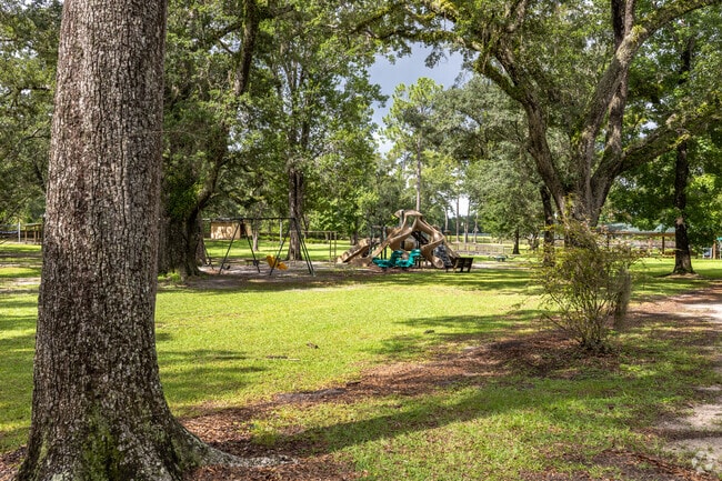 Tall pines surround Honeville Park’s playground and community center in Wewahitchka.