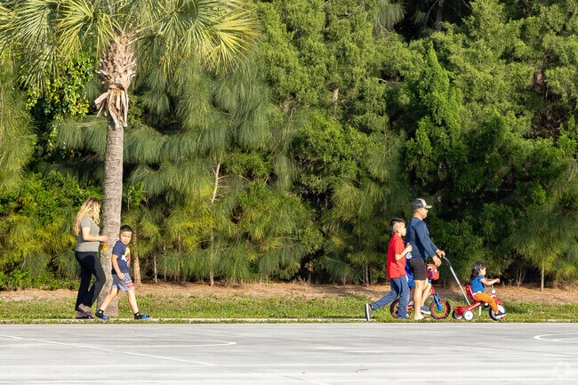 A Riverwalk family enjoys a leisurely evening stroll in the park.