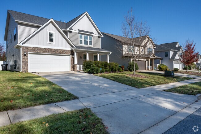 Most homes feature large garages and paved driveways in Sandy Ridge neighborhood.