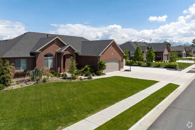 A large brick home with a large landscaped front yard in West Point.