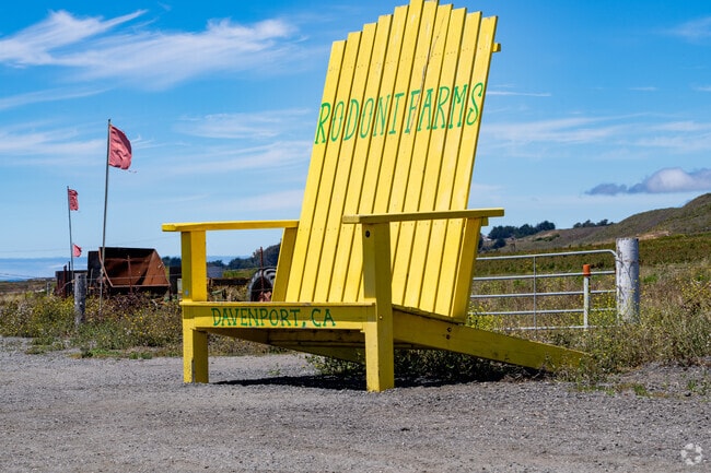 Landmark yellow chair sits beside fresh produce stands at Rodoni Farms near Davenport.
