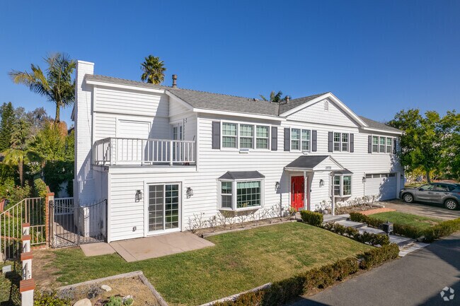 A beautiful red door adorns this coastal North Costa Mesa beauty.