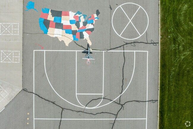A basketball court next to a colorfully painted map of the United States at Woodstock Elementary