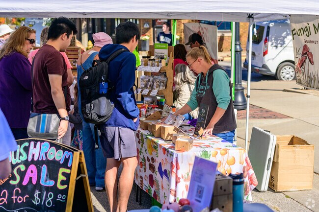 A vendor shares her mushrooms with patrons at the Lafayette Farmer's Market near Old Romney.