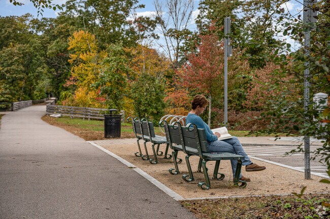 Enjoy some light reading on a park bench along the Greenway in Blackstone.