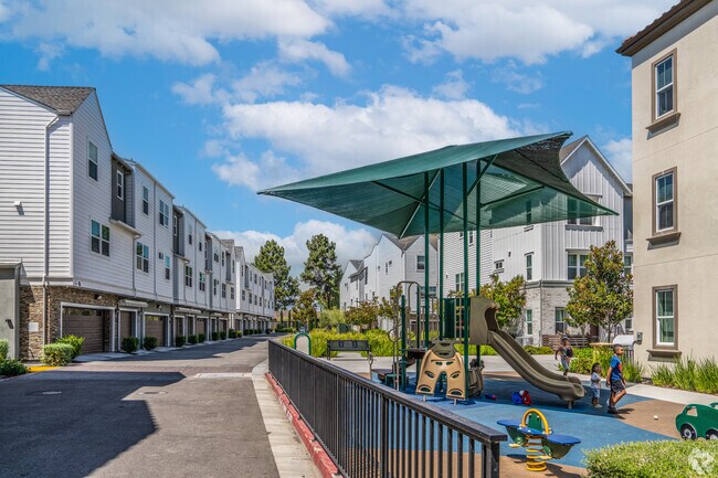 Modern townhome with a play structure, blending stylish living with family-friendly fun.