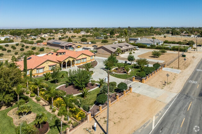 Northwest Palmdale’s Spanish-style homes sit near trees and peaceful residential roads.