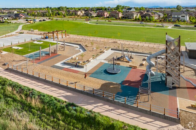 Families gather and kids laugh at Dovetail Park in Bucking Horse, Colorado, where shaded benches, wide lawns, and fun structures create the perfect place to relax, play, and soak up Colorado sunshine.