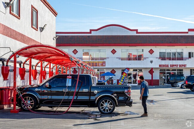 A man drying and vacuuming his truck at a local car wash in Cudahy.