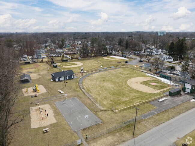 Carman Park features a large athletic field and playground for locals in Rotterdam.
